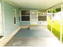 Covered patio with concrete flooring and access to the front door at 36819 Kiowa Ave, Zephyrhills, FL 33542