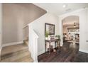 Bright entryway with hardwood floors, staircase, and view into the living area at 5701 S Macdill Ave, Tampa, FL 33611