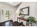 Entryway with hardwood floors, a console table, and a view of the front yard at 5701 S Macdill Ave, Tampa, FL 33611