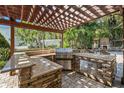 Outdoor kitchen with granite countertops and built-in grill at 5701 S Macdill Ave, Tampa, FL 33611