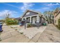 Charming bungalow with a gray exterior and a well-maintained yard at 915 E 20Th Ave, Tampa, FL 33605