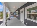 Covered porch with white columns and gray siding at 915 E 20Th Ave, Tampa, FL 33605