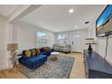 Bright living room with comfy blue couch and decorative rug at 915 E 20Th Ave, Tampa, FL 33605