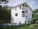 Rear view of two-story home with pool and patio at 96 Shore Dr, Tarpon Springs, FL 34689
