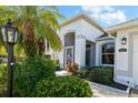 Front entrance of the home with lush landscaping and walkway at 10038 Reagan Dairy Trl, Bradenton, FL 34212
