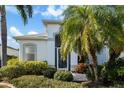 Front entrance with a screened door and tropical landscaping at 10038 Reagan Dairy Trl, Bradenton, FL 34212