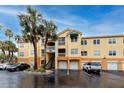 Condo building exterior with palm trees and parking at 10764 70Th Ave # 1303, Seminole, FL 33772