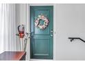 Green front door with wreath and golf clubs beside it at 1157 Eden Isle Ne Blvd # 3, St Petersburg, FL 33704