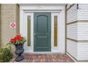 Green front door entry with sidelights and brick walkway at 1157 Eden Isle Ne Blvd # 3, St Petersburg, FL 33704