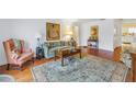 Living room with hardwood floors, area rug, and comfy seating at 1157 Eden Isle Ne Blvd # 3, St Petersburg, FL 33704