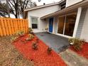 Neatly landscaped front yard with a wooden fence and red mulch at 13901 Bardmoor Pl # A, Tampa, FL 33618