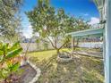 Spacious backyard with a fire pit and lush greenery at 14721 Condor Pass, Clearwater, FL 33760
