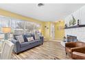 Living room with fireplace, hardwood floors, and large windows at 1560 Simmons Dr, Clearwater, FL 33756