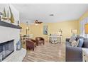 Living room with fireplace, hardwood floors, and coastal decor at 1560 Simmons Dr, Clearwater, FL 33756