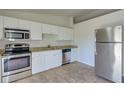 Modern kitchen with stainless steel appliances and granite countertops at 2369 N Biscayne Dr, North Port, FL 34291