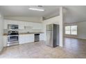 Eat-in kitchen with stainless steel appliances and granite countertops at 2369 N Biscayne Dr, North Port, FL 34291