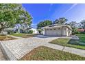 Property showcasing a brick-paved driveway and walkway at 3028 Summervale Dr, Holiday, FL 34691
