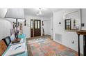 Bright entryway with rug, console table, and mirror at 3031 W Asbury Pl, Tampa, FL 33611