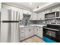 Modern kitchen with stainless steel appliances and gray cabinets at 3100 Hartford N St # 224, St Petersburg, FL 33713