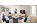 Bright living room with comfy sofas, coffee table, and large TV at 3100 Hartford N St # 224, St Petersburg, FL 33713