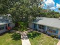 Two tan houses with blue shutters and a shared yard at 402 Dorchester Pl # 28, Sun City Center, FL 33573