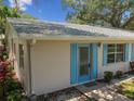 Tan house with blue shutters and walkway at 402 Dorchester Pl # 28, Sun City Center, FL 33573