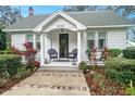 White house with a porch and well-manicured landscaping at 4156 Mcintosh Rd, Dover, FL 33527