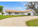 White single story home with terracotta roof and circular driveway at 4500 38Th S St, St Petersburg, FL 33711