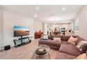 Open living room showcasing a sectional sofa and kitchen views at 6320 Cliveden Ct, Apollo Beach, FL 33572