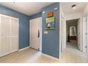 Bright entryway with light wood flooring, white louvered doors, and a view of the living area at 804 67Th W St, Bradenton, FL 34209