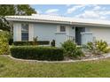 Side view of a light blue house with well-maintained landscaping at 804 67Th W St, Bradenton, FL 34209