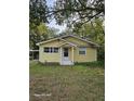 Charming yellow house with a well-maintained lawn at 908 N Gordon St, Plant City, FL 33563