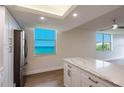 Modern kitchen with white cabinets and ocean view at 100 Oakmont Ln # 309, Belleair, FL 33756