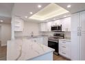 Modern white kitchen with stainless steel appliances at 100 Oakmont Ln # 309, Belleair, FL 33756