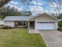 House exterior with a two-car garage and landscaping at 1559 Glengarry Dr, Palm Harbor, FL 34684