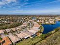 Aerial view of a house in a residential community near a lake at 16122 Cedar Key Dr, Wimauma, FL 33598