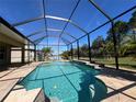 Relaxing screened-in pool with a spa, surrounded by a spacious patio at 16122 Cedar Key Dr, Wimauma, FL 33598