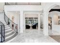 Bright and spacious foyer with marble floors and a curved staircase at 16220 Villarreal De Avila, Tampa, FL 33613