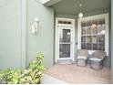 Cozy front porch with wicker chairs, inviting entryway, and landscaping at 2135 Park Crescent Dr, Land O Lakes, FL 34639
