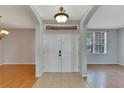 Bright entryway with double doors and wood flooring at 2715 Durant Trails Blvd, Dover, FL 33527