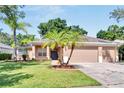 Two-story house with a three car garage and lush landscaping at 2715 Durant Trails Blvd, Dover, FL 33527