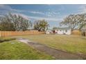 Large backyard with a wooden fence and deck at 3111 Bay Ln, Clearwater, FL 33759