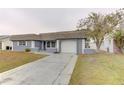 Inviting single-story home with a tidy front yard and a paved driveway at 3205 Moog Rd, Holiday, FL 34691