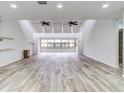 Spacious living room with vaulted ceilings and wood-look tile floors at 40 Aster Pl, Oldsmar, FL 34677