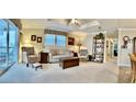 Spacious living room with comfy seating, large windows, and wood shelving at 614 Leisure, Venice, FL 34285