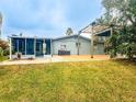 Backyard with patio, pergola, screened porch, and grassy area at 6627 Beach Blvd, Hudson, FL 34667