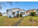 House with a single car garage and a manicured lawn at 704 E Broad St, Tampa, FL 33604