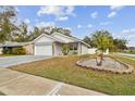 Charming one-story house featuring a two-car garage and manicured lawn at 7101 69Th N St, Pinellas Park, FL 33781
