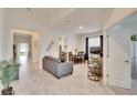 Bright living room with gray sofas and tile floors at 7102 Wesley Palm Way, Wesley Chapel, FL 33545
