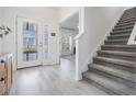 Modern entryway with gray carpeting and open floor plan at 7678 Notched Pine Bnd, Wesley Chapel, FL 33545